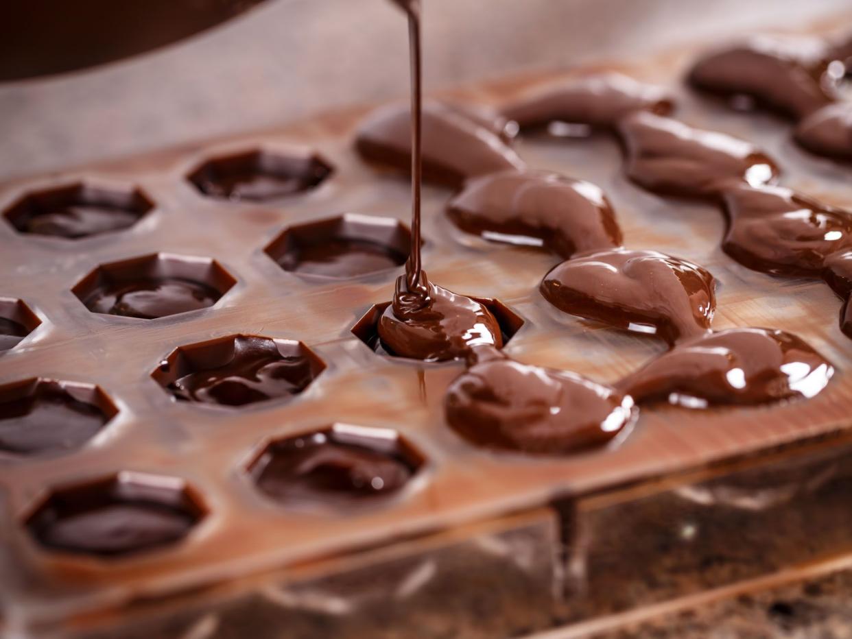 Putting chocolate in mold, make praline
