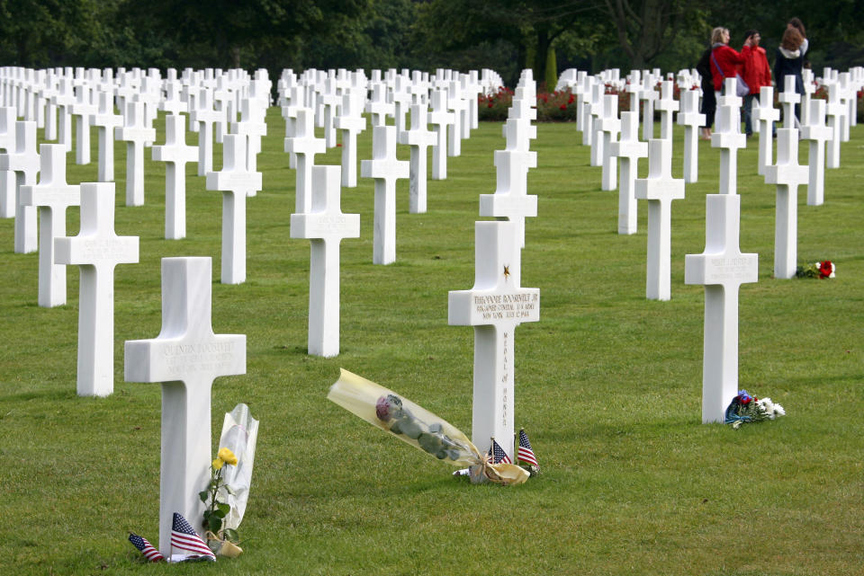 FILE - This June 6, 2011 file photo shows tourists visiting the U.S military cemetery in Colleville sur Mer, western France, for the D Day Anniversary. This year is the 70th anniversary of D-Day, where Allied forces landed in Normandy on June 6, 1944 during World War II. (AP Photo/Vincent Michel)