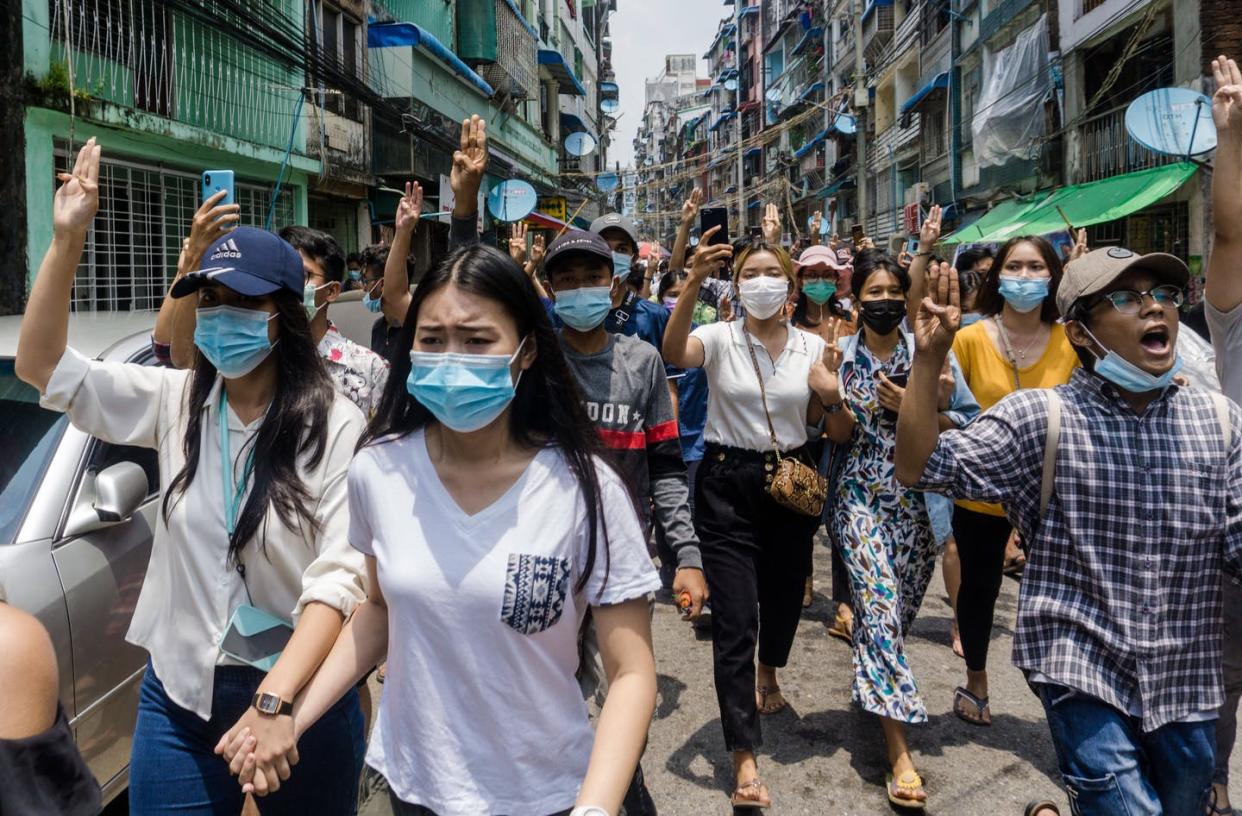 <span class="caption">Young women are on the front lines of the anti-coup protesters in Myanmar, defying traditional gender roles. </span> <span class="attribution"><a class="link " href="https://www.gettyimages.com/detail/news-photo/protesters-make-the-three-finger-salute-during-a-news-photo/1232553837?adppopup=true" rel="nofollow noopener" target="_blank" data-ylk="slk:STR/AFP via Getty Images;elm:context_link;itc:0;sec:content-canvas">STR/AFP via Getty Images</a></span>