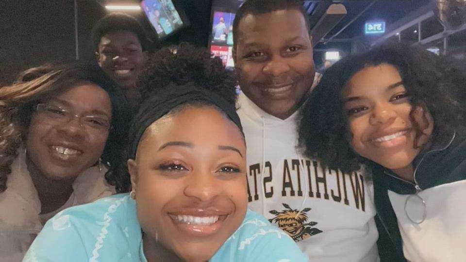 Zaiylah Bronson (center, blue) with her family. The 19-year-old's family is mourning her loss after she died unexpectedly in August 2023.