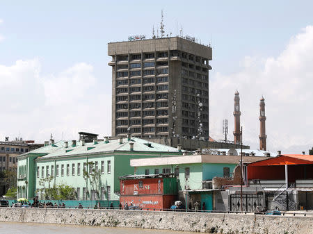 Men carry injured people outside the building of Ministry of Communication and Information Technology in Kabul, Afghanistan April 20, 2019. REUTERS/Mohammad Ismail