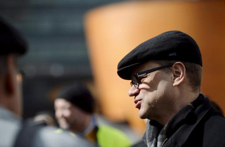 The leader of Finnish Centre Party, Juha Sipila (R), chats with voters during an election campaign on April 14, 2015 in Helsinki