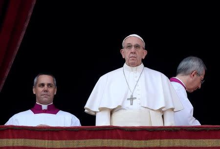 Pope Francis arrives to leads "Urbi et Orbi" (to the city and the world) message from the balcony overlooking St. Peter's Square at the Vatican December 25, 2016. REUTERS/Alessandro Bianchi