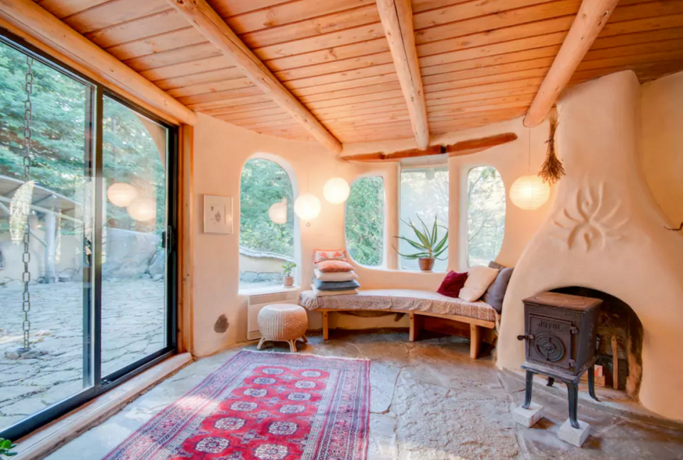 <p>The cabin has plenty of natural light, including in the family room, which is perfect for cozying up with a book. (Airbnb) </p>