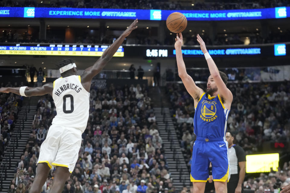 Golden State Warriors guard Klay Thompson (11) shoots a 3-point basket against Utah Jazz forward Taylor Hendricks (0) during the second half of an NBA basketball game Thursday, Feb. 15, 2024, in Salt Lake City. (AP Photo/Rick Bowmer)