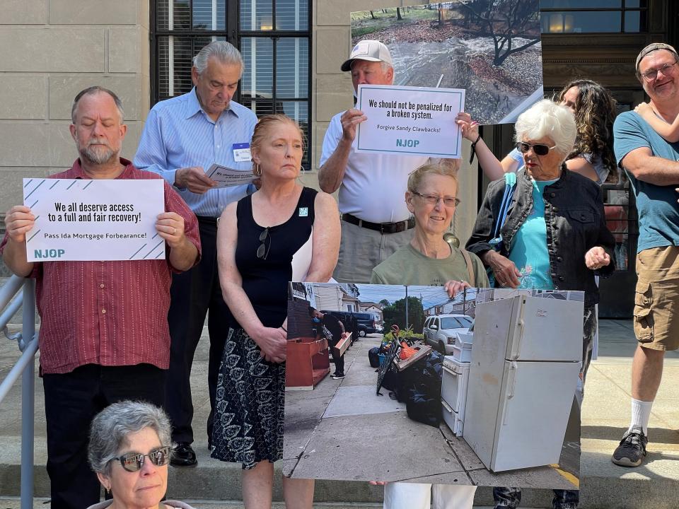 Victims of the storms Ida and Sandy gather on the steps of the Statehouse in Trenton to urge legislators to pass new bills to help with recovery and rebuilding efforts.