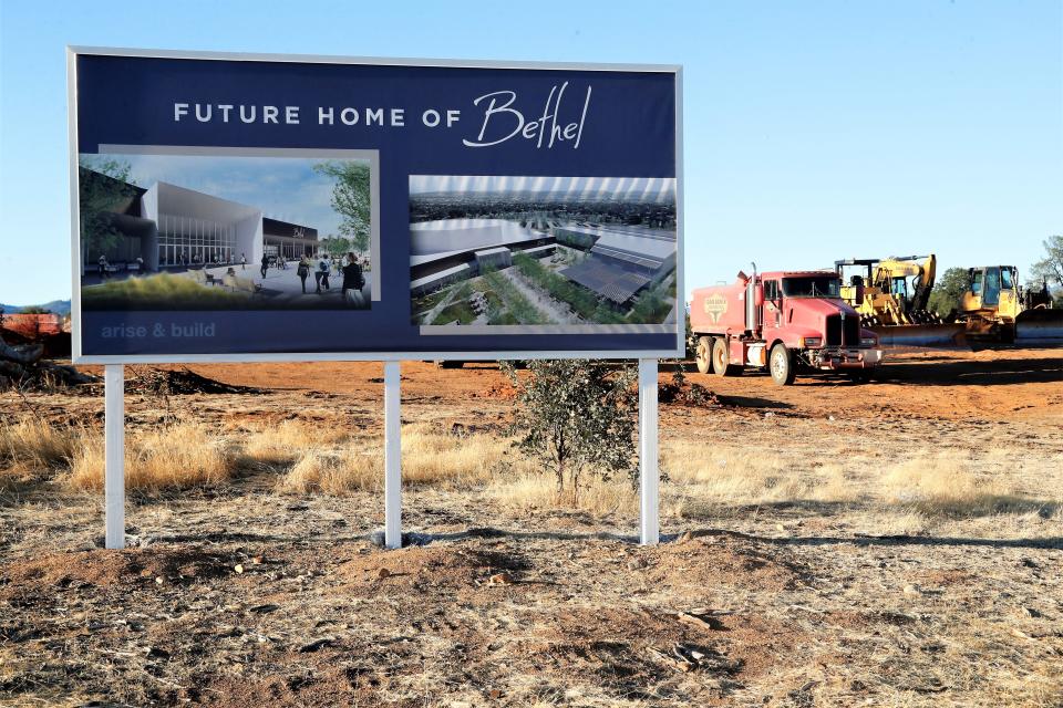 A sign stands next to lot-cleaning machinery where Bethel Church plans to build its new $96 million campus off Collyer Drive in east Redding, shown here on Wednesday, Sept. 29, 2021.