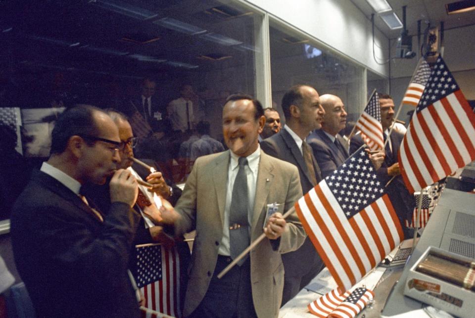 NASA and Manned Spacecraft Center (MSC) officials join the flight controllers in celebrating the conclusion of the Apollo 11 mission on July 24, 1969. From left foreground Dr. Maxime A. Faget, MSC Director of Engineering and Development; George S. Trimble, MSC Deputy Director; Dr. Christopher C. Kraft Jr., MSC Director fo Flight Operations; Julian Scheer (in back), Assistant Adminstrator, Office of Public Affairs, NASA HQ.; George M. Low, Manager, Apollo Spacecraft Program, MSC; Dr. Robert R. Gilruth, MSC Director; and Charles W. Mathews, Deputy Associate Administrator, Office of Manned Space Flight, NASA HQ. (Photo: NASA)