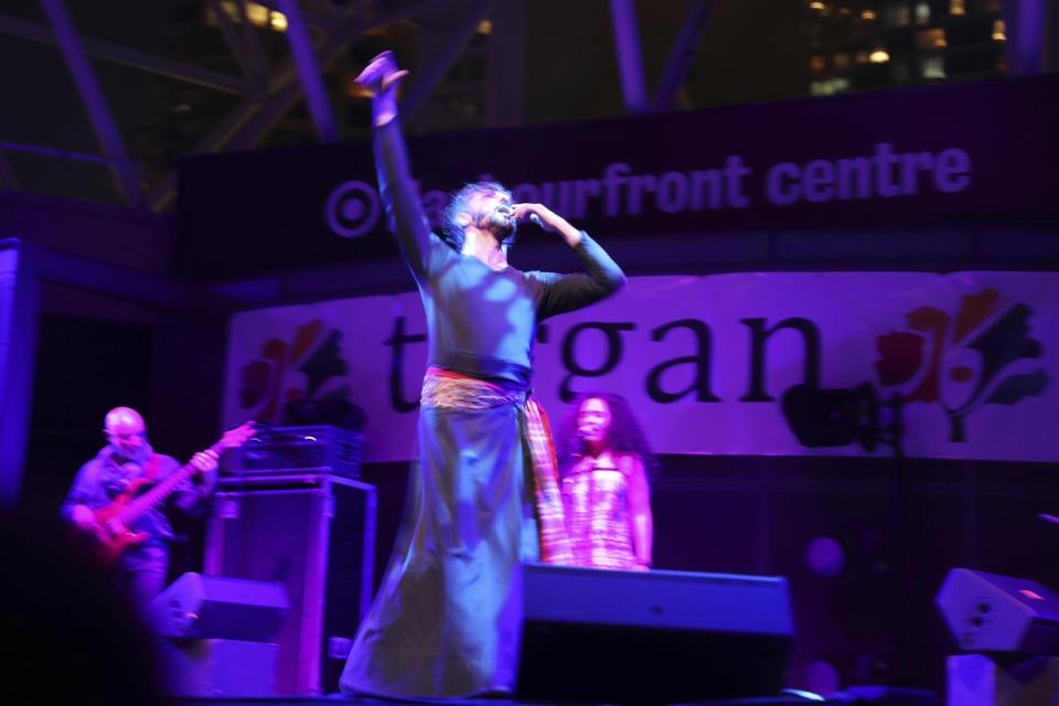 In this Thursday, July 25, 2019 photo, Shahrokh Moshkin Ghalam, Iranian modern dancer, performs with Manushan Band during the opening ceremony of the Tirgan summer festival at the Harbourfront Centre in Toronto, Canada. The event aims to preserve and celebrate Iranian and Persian culture, said festival CEO Mehrdad Ariannejad. Among those who attended were second-and third-generation immigrants, many of whom have never been to Iran or have not been there since leaving the country following the 1979 Islamic Revolution. (AP Photo/Kamran Jebreili)