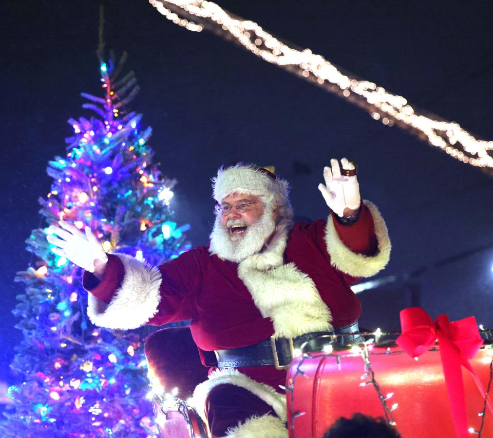 Santa waves to the crowd during the annual Holiday Parade of Lights in Stoughton on Saturday, Dec. 11, 2021.