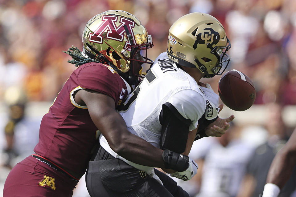 RETRANSMISSION TO CORRECT ID TO TERELL SMITH - Minnesota defensive back Terell Smith (4) knocks the ball from Colorado quarterback J.T. Shrout (5) during the first half of an NCAA college football game, Saturday, Sept. 17, 2022, in Minneapolis. (AP Photo/Stacy Bengs)