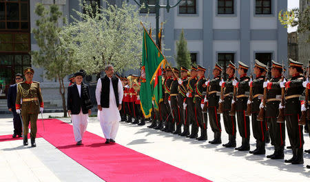 Afghanistan's President Ashraf Ghani and Pakistani Prime Minister Shahid Khaqan Abbasi inspect the honor guard at the presidential palace in Kabul, Afghanistan April 6, 2018. Presidential palace/ Handout via REUTERS