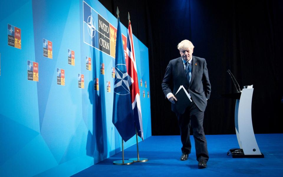 Boris Johnson, the Prime Minister, is pictured leaving the stage after his press conference at the Nato summit in Madrid today - Reuters