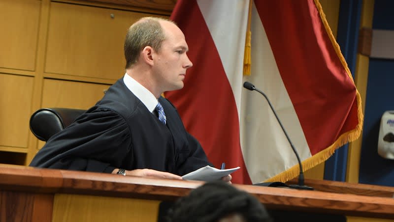 Judge Scott McAfee presides during a hearing on charges against former President Donald Trump in the Georgia election interference case on Thursday, March 28, 2024, in Atlanta. Lawyers for Trump argued in a court filing that the charges against him in the Georgia election interference case seek to criminalize political speech and advocacy conduct that is protected by the First Amendment.