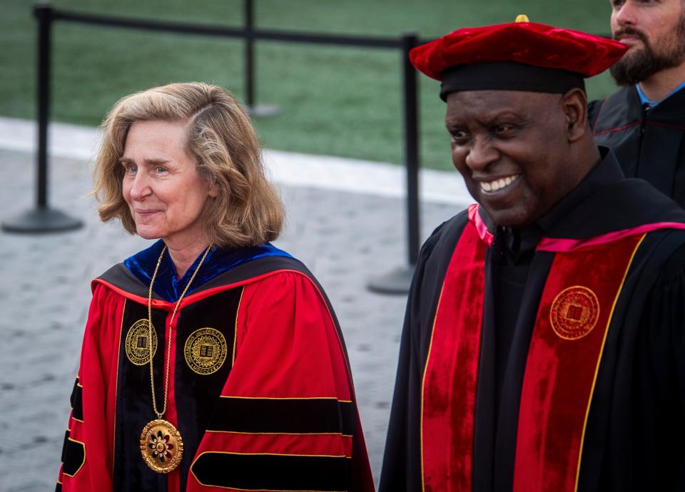 Indiana University President Pamela Whitten, left, and Board of Trustees Chair. W. Quinn Buckner walk in during Indiana University's 195th undergraduate commencement proceedings at Memorial Stadium on Saturday, May 4, 2024.