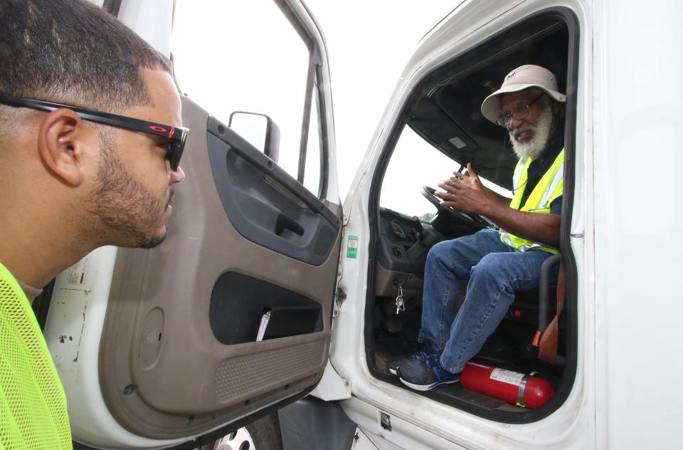 Reynaldo Germosen, left, gets instruction from Randy Mack during a training session at Transenergy CDL Academy in the parking area at the Eastridge Mall Monday morning, Aug. 22, 2022.