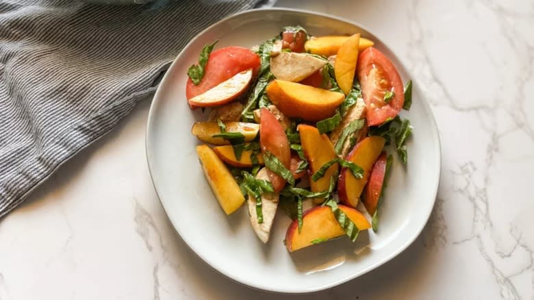 Peach Caprese salad on white plate