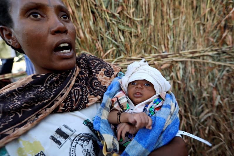 FILE PHOTO: An Ethiopian refugees fleeing from the ongoing fighting in Tigray region, holds her new born baby at the Um-Rakoba camp, on the Sudan-Ethiopia border, in the Al-Qadarif state