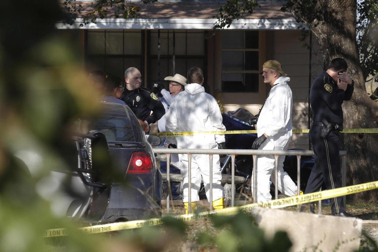 Law enforcement and forensic officials gather near the First Baptist Church following a shooting on November 5, 2017 in Sutherland Springs, Texas: Getty