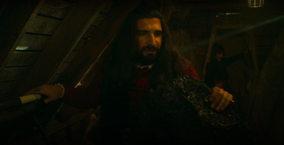 Nandor, high on drug blood, holding on to the Stairmaster, in "What We Do in the Shadows"
