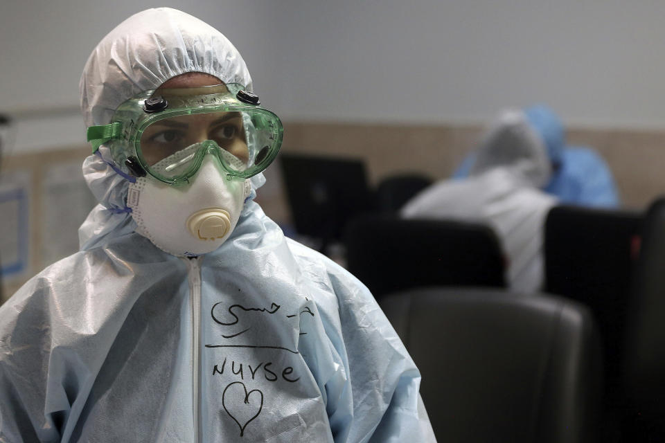 FILE - In this March 8, 2020 file photo, a nurse wears protective gear in a ward dedicated for people infected with the new coronavirus, at a hospital in Tehran, Iran. While crippling sanctions imposed by the U.S. government left the country ill-equipped to deal with the fast-moving virus, some medical professionals say government and religious leaders bear the brunt of the blame for allowing the virus to spread -- and for hiding how much it had spread. (AP Photo/Mohammad Ghadamali, File)