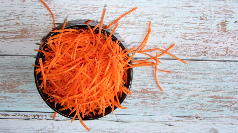 Thinly grated carrot in bowl