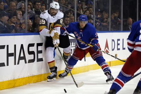 Dec 16, 2018; New York, NY, USA; Vegas Golden Knights right wing Alex Tuch (89) battles for the puck aganst New York Rangers defenseman Fredrik Claesson (33) during the third period at Madison Square Garden. Mandatory Credit: Adam Hunger-USA TODAY Sports