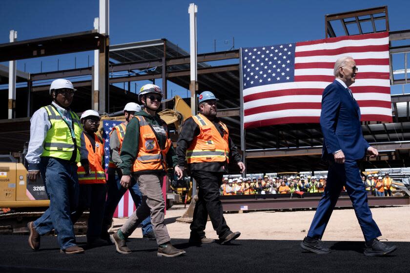 TOPSHOT - US President Joe Biden arrives with union members to speak after touring Intel's Ocotillo Campus in Chandler, Arizona, on March 20, 2024. The White House unveiled almost $20 billion in new grants and loans Wednesday to support Intel's US chip-making facilities, marking the Biden administration's largest funding announcement yet as it tackles China's dominance of the crucial technology. (Photo by Brendan Smialowski / AFP) (Photo by BRENDAN SMIALOWSKI/AFP via Getty Images)