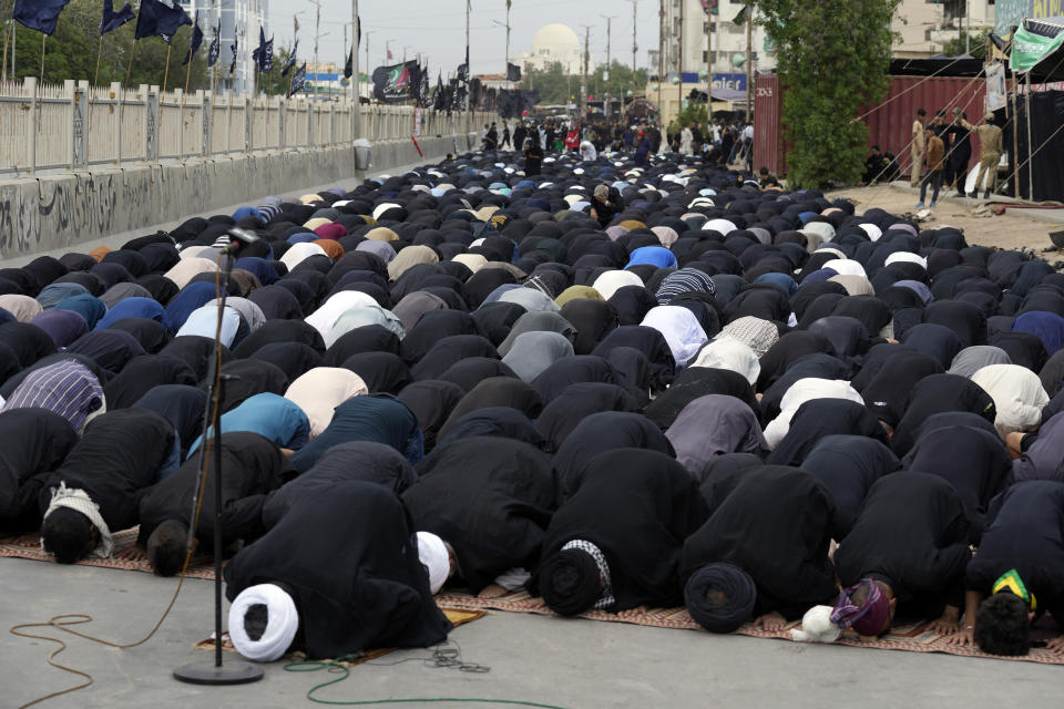 Shiite Muslims pray during a procession to mark Ashoura in Karachi, Pakistan, Friday, July 28, 2023. Ashoura is the Shiite Muslim commemoration marking the death of Hussein, the grandson of the Prophet Muhammad, at the Battle of Karbala in present-day Iraq in the 7th century. (AP Photo/Fareed Khan)