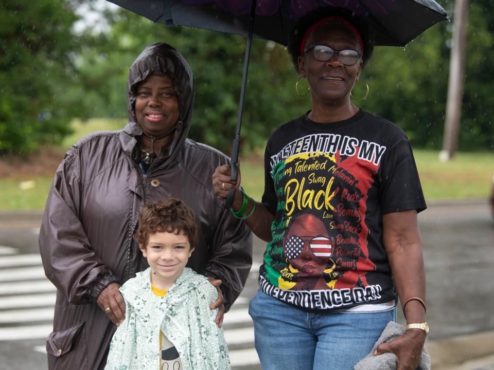 Sherry Fichback, Terry Burns and Mason Bomar anticipate the arrival of the MLK Memorial Parade and Juneteenth Celebration on June 19.