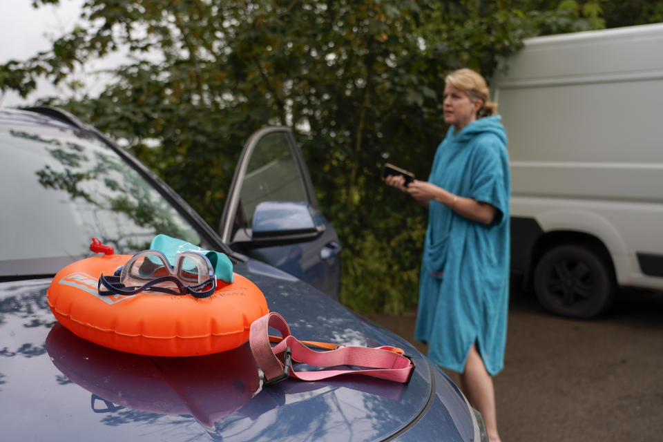 Jo Robb, member of the open water swimming group Henley Mermaids, prepares for a swim in the river, in Henley-on-Thames, England, Friday, June 14, 2024. Britain has become notorious as a place where a casual swim could lead to an extended visit to the toilet, if not the hospital. A torrent of news on dirty water has spilled into next month's election to determine which party controls government for the next four or five years. (AP Photo/Alberto Pezzali)