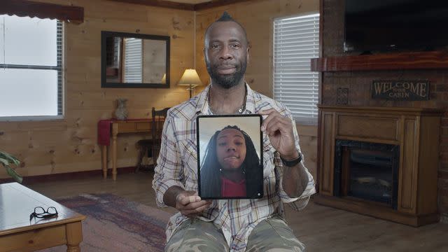 <p>courtesy netflix</p> Stephen Chukumba holding a photo of his son Hobbes.