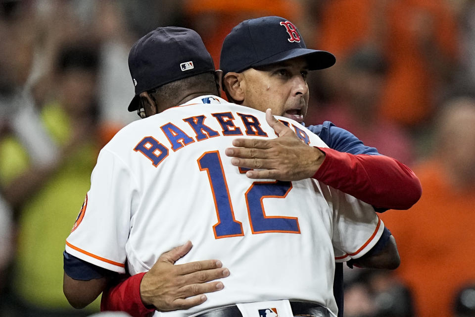 Boston Red Sox manager Alex Cora, hugs Houston Astros manager Dusty Baker Jr. during introductions before Game 1 of baseball's American League Championship Series against the Houston Astros Friday, Oct. 15, 2021, in Houston. (AP Photo/David J. Phillip)