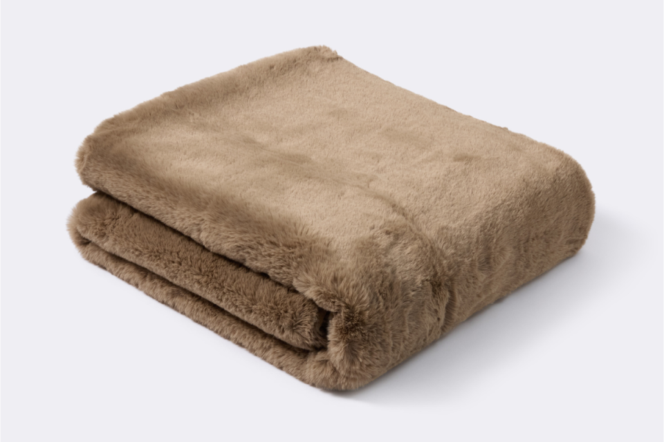 Brown BIG W faux mink blanket on a grey background