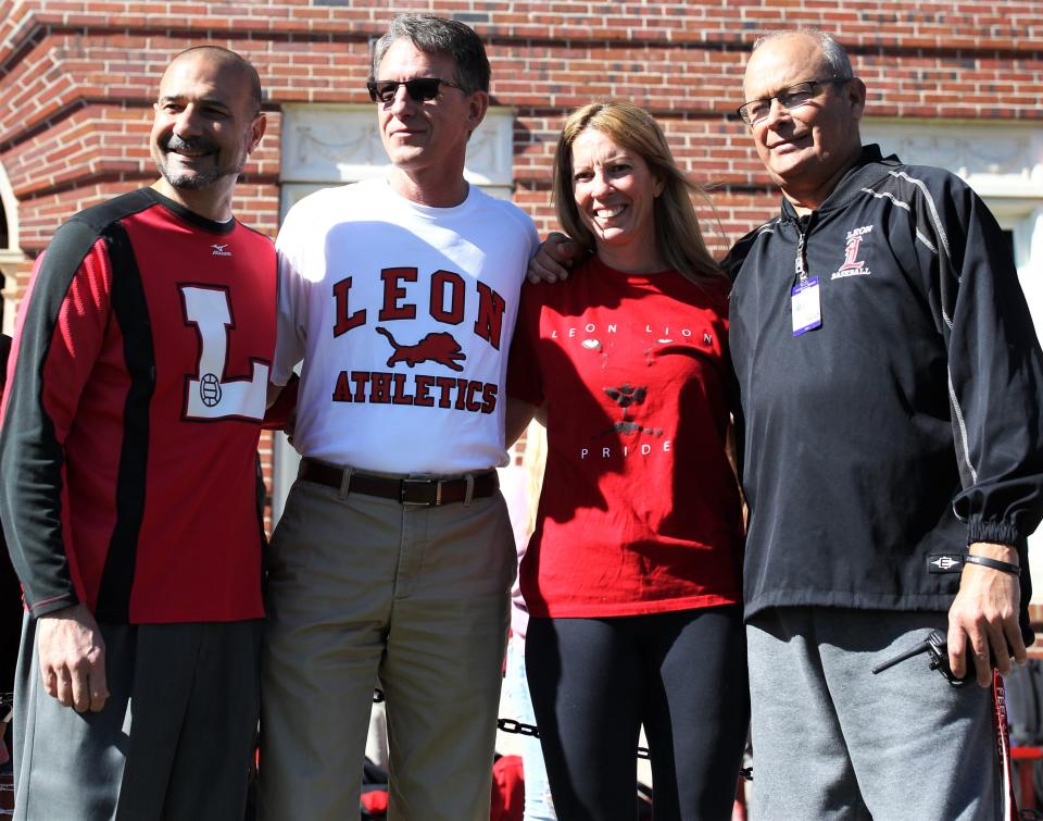 Leon County superintendent Rocky Hanna, Leon High principal Billy Epting, Leon volleyball coach Angie Strickland and athletic director Mark Feely pose for a photo after Leon's volleyball team captured a Class 6A state championship and celebrated on its grounds on Nov. 21, 2019.