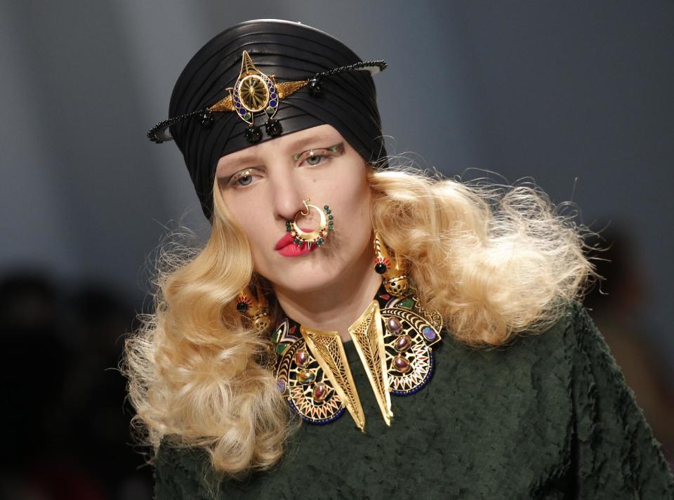 A model presents a creation by Indian fashion designer Manish Arora Ready to Wear's Fall-Winter 2013-2014 fashion collection, presented, Thursday, Feb.28, 2013 in Paris. (AP Photo/Christophe Ena)