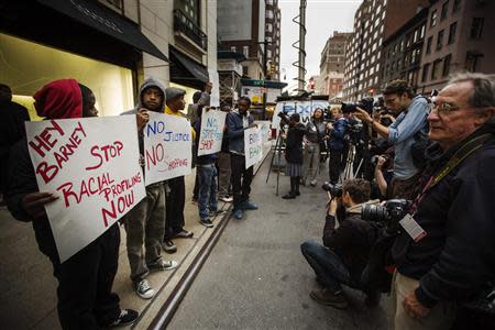 Demonstrators stand in front of a Barneys luxury department store of with signs decrying allegations that Barney's and Macy's stores have unfair security policies aimed at minorities in New York October 30, 2013. REUTERS/Lucas Jackson