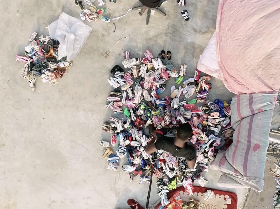 Vendor sifting through clothing