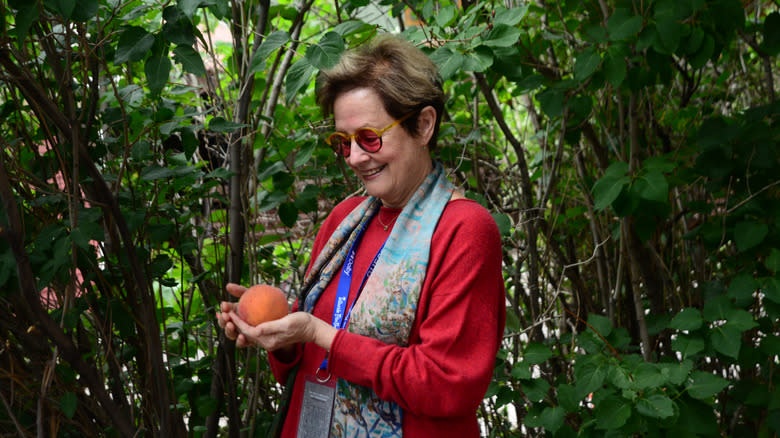 Alice Waters holding fruit