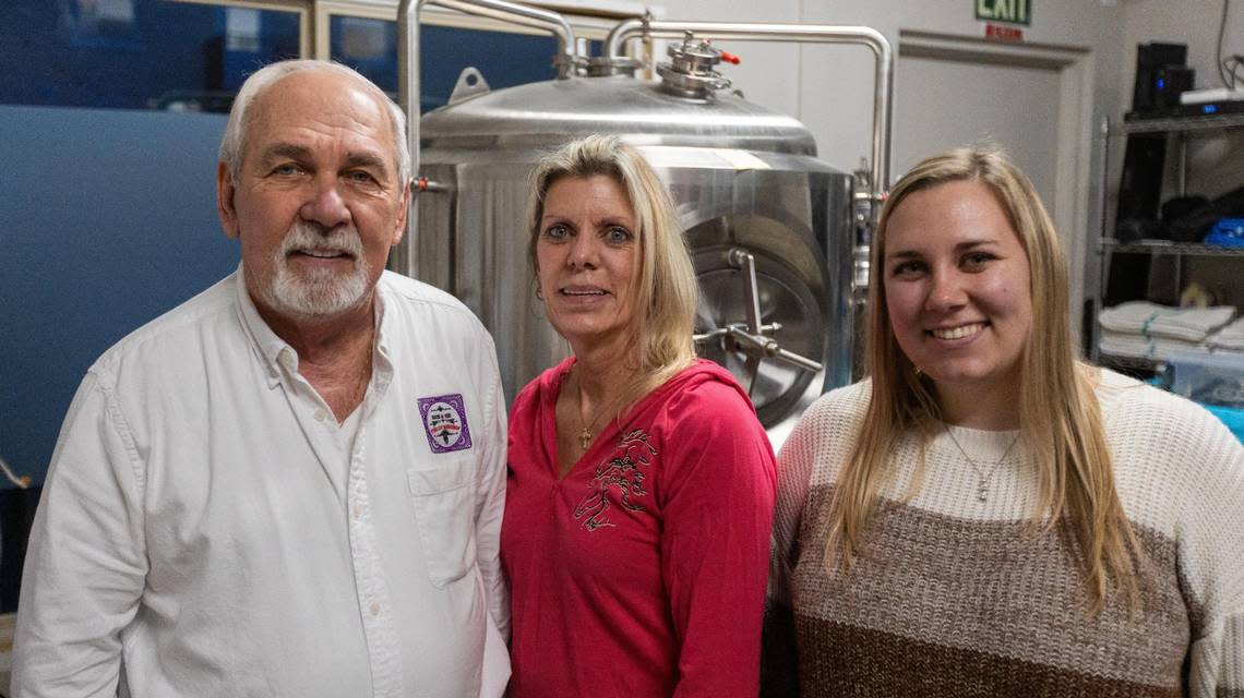 Robert and Alberta Davies, center, with daughter Sofia Amburgey, right, in the brewery of Sterling Microbrew in Mt. Sterling. January 25, 2024. Marcus Dorsey/mdorsey@herald-leader.com