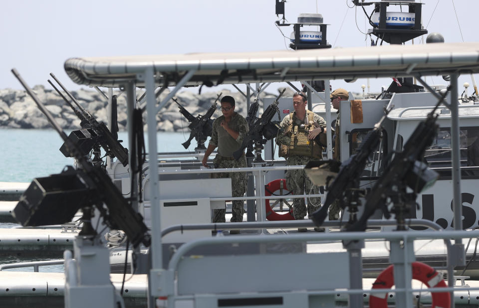 U.S. Navy personnels prepare patrol boats to carry journalists to see damaged oil tankers at a U.S. Navy 5th Fleet base, during a trip organized by the Navy for journalists, near Fujairah, United Arab Emirates, Wednesday, June 19, 2019. Cmdr. Sean Kido of the U.S. Navy's 5th Fleet said Wednesday that the limpet mine used on a Japanese-owned oil tanker last week "bears a striking resemblance" to similar Iranian mines. (AP Photo/Kamran Jebreili)