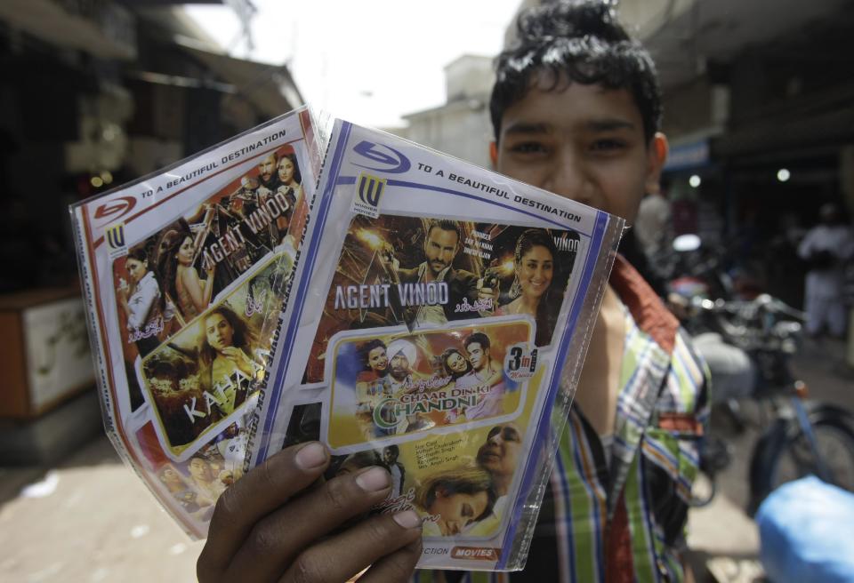 A Pakistani boy shows CDs of Indian film Agent Vinod he bought from a store in Karachi, Pakistan on Monday, March 26, 2012. The Indian James Bond, Agent Vinod, can disarm a bomb while flying a helicopter, dodge bullets from deadly assassins and save his country from nuclear disaster, but getting into cinemas in Pakistan has proved to be an impossible feat, after Agent Vinod's critical portrayal of the country's generals and spies and shows Pakistan providing support for the Taliban in Afghanistan. (AP Photo)