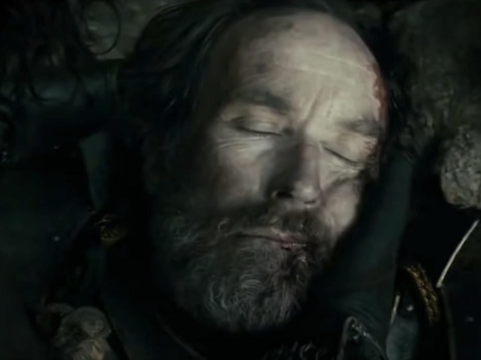 Elendil with his eyes closed on the ground in lord of the rings