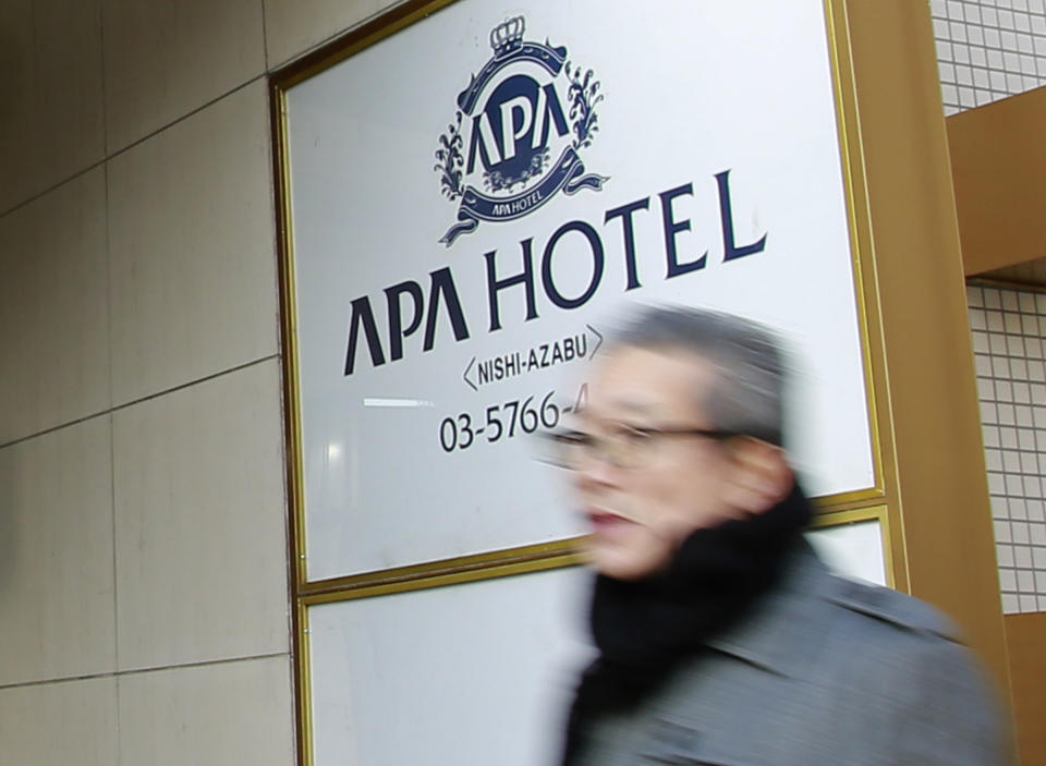 A man walks past the entrance of an Apa Hotel in Tokyo, Wednesday, Jan. 18, 2017. The fast-growing Japanese hotel chain is facing criticism over a book penned by the hotel’s owner that says the Rape of Nanking was fabricated. APA Group, a Tokyo-based land developer and operator of 400-plus hotels, drew fire for spreading the revisionist views of company president Toshio Motoya by putting the books in hotel guestrooms and also selling them. (AP Photo/Shizuo Kambayashi)