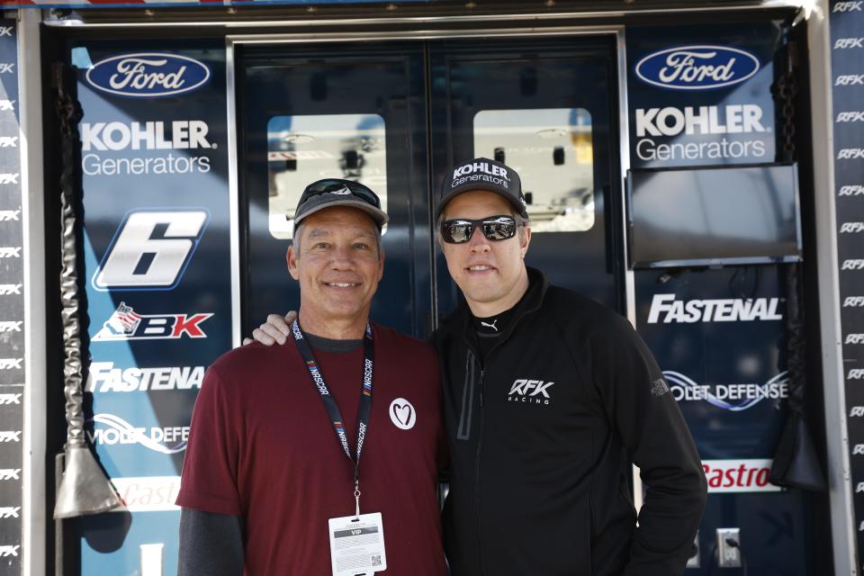 NASCAR driver Brad Keselowski (right) meets with Ralph Maccarone, winner of the NASCAR Foundation's 2022 Betty Jane France Humanitarian Award, earlier in November at Phoenix Raceway in Avondale, Arizona.