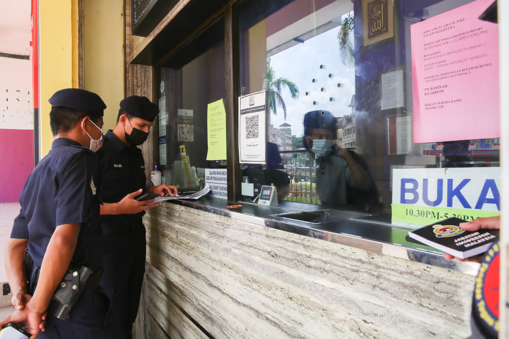 Enforcement officers (Police, Immigration and Army) checking the standard operating procedure (SOP) compliance at shops in Putrajaya, June 14, 2021. — Picture by Choo Choy May