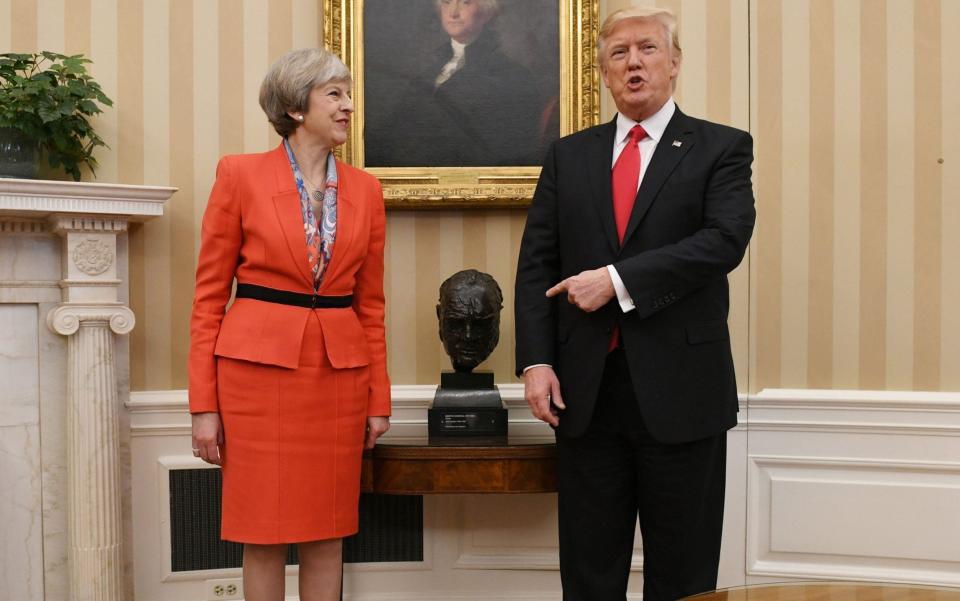 Prime Minister Theresa May meeting US President Donald Trump by a bust of Sir Winston Churchill in the Oval Office - Stefan Rousseau/PA