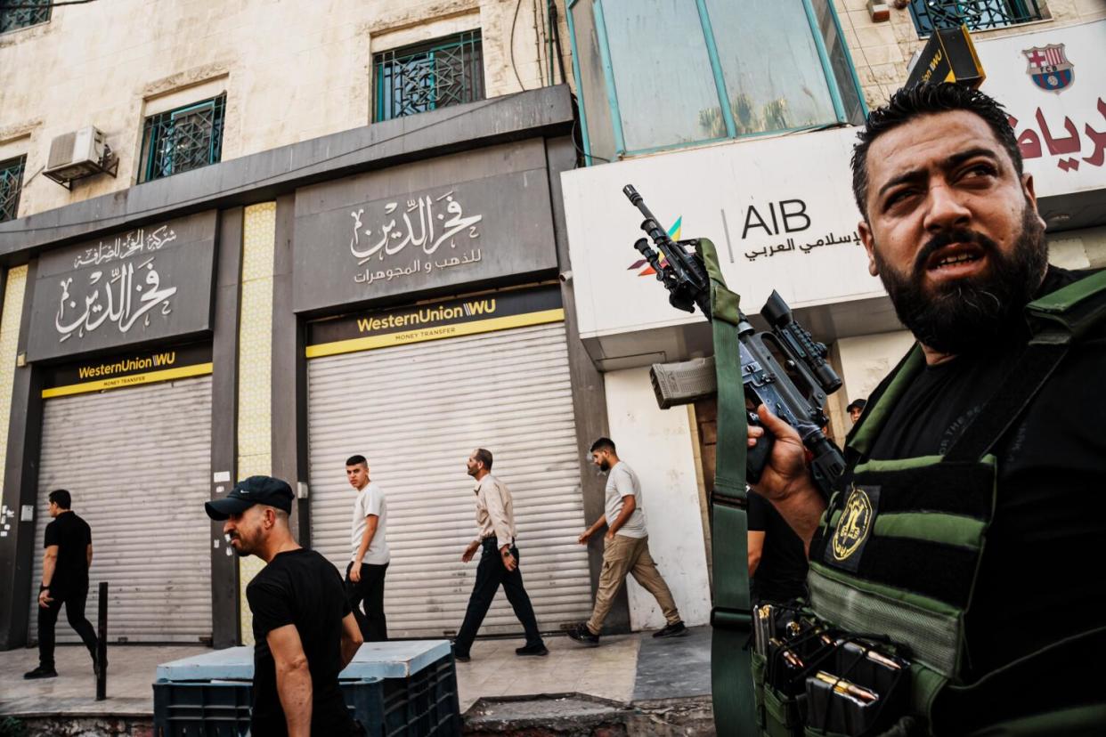 Palestinian fighters at a funeral procession