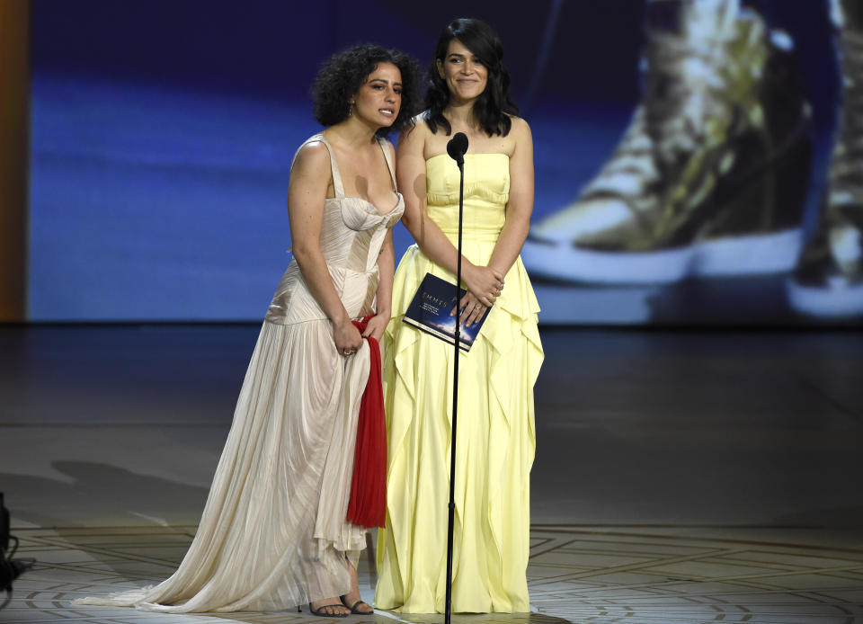 Ilana Glazer, left, and Abbi Jacobson present the award for outstanding writing for a variety special at the 70th Primetime Emmy Awards on Monday, Sept. 17, 2018, at the Microsoft Theater in Los Angeles. (Photo by Chris Pizzello/Invision/AP)