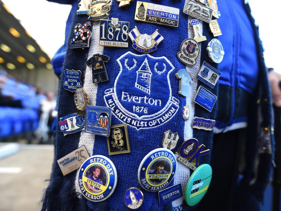 A fan displays their Everton pin badge collection (Getty Images)